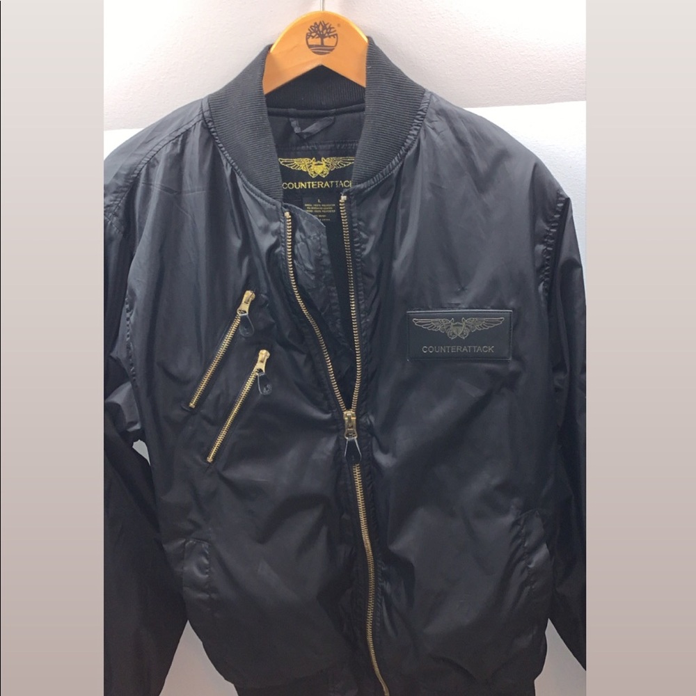 A Black with gold zipper bomber jacket